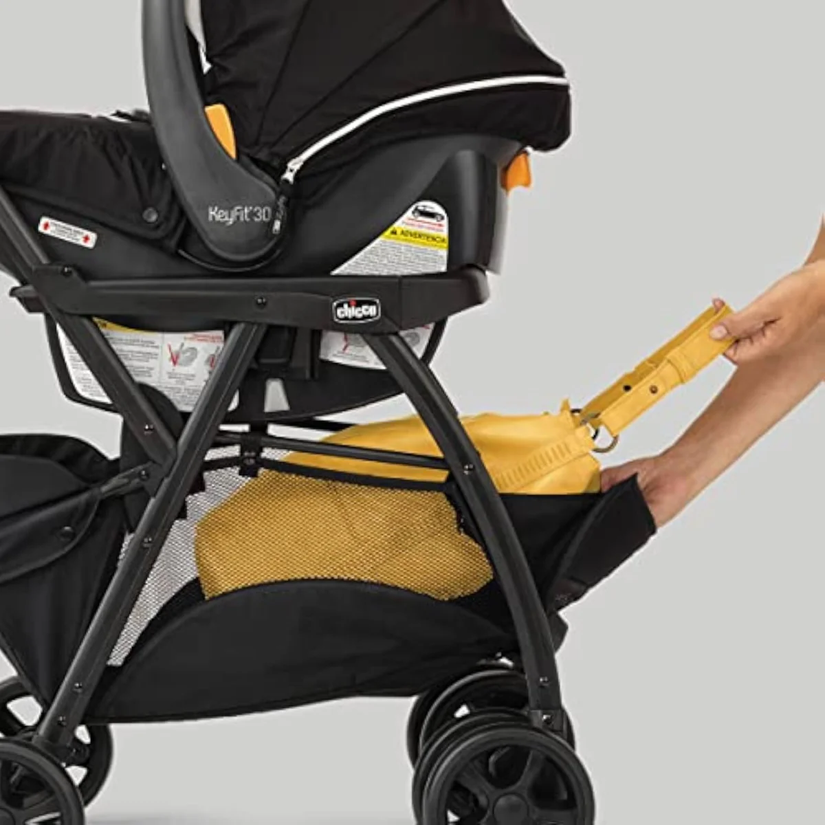A Chicco frame stroller — an aluminum frame that holds an infant car seat, with no seat of its own