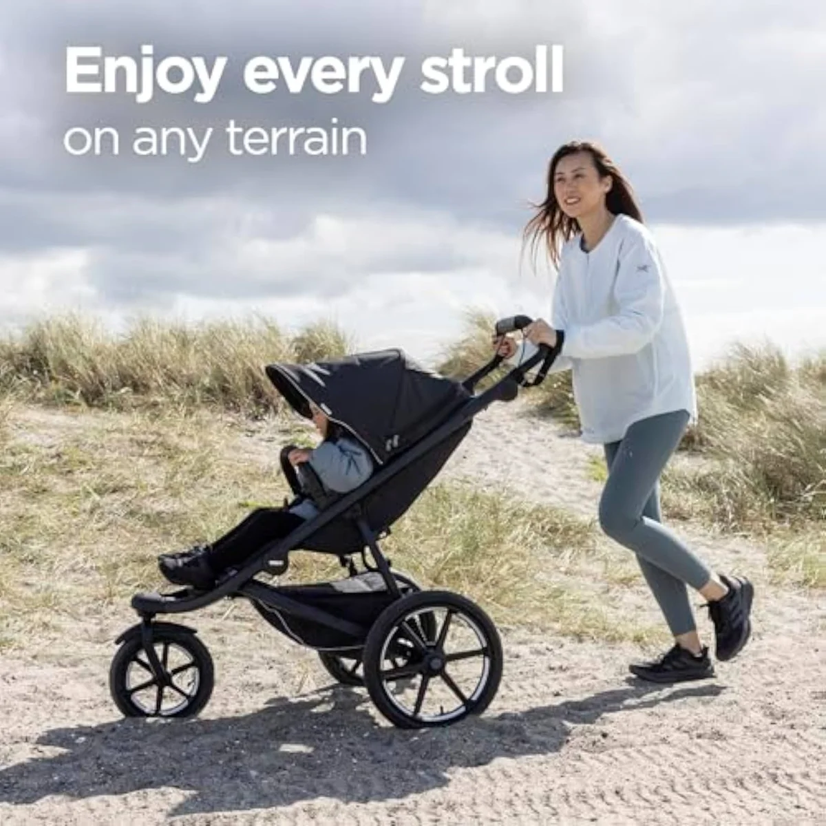 The Thule Urban Glide 3 single-child all-terrain jogging stroller shown from the side, with its single swivel front wheel and air-filled tires